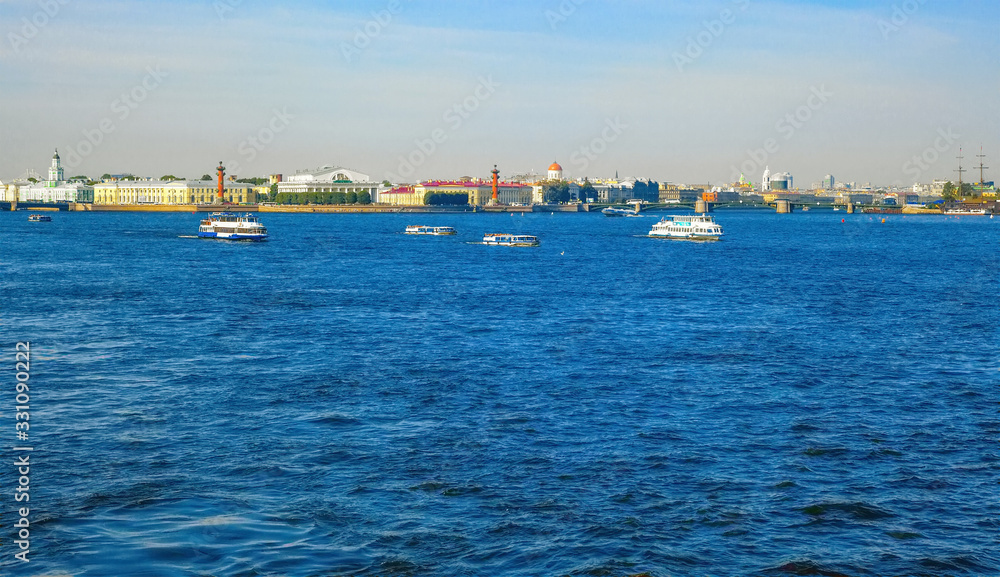 Pleasure tourist boats and ships in the Neva River in St. Petersburg, on a summer day