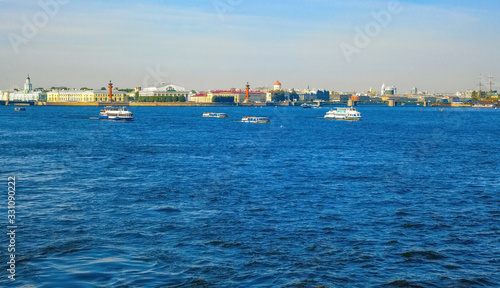 Pleasure tourist boats and ships in the Neva River in St. Petersburg  on a summer day
