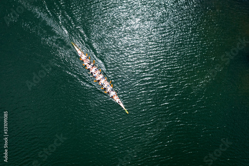 Fotografiet Sport dragon boat of 20 paddlers, top view