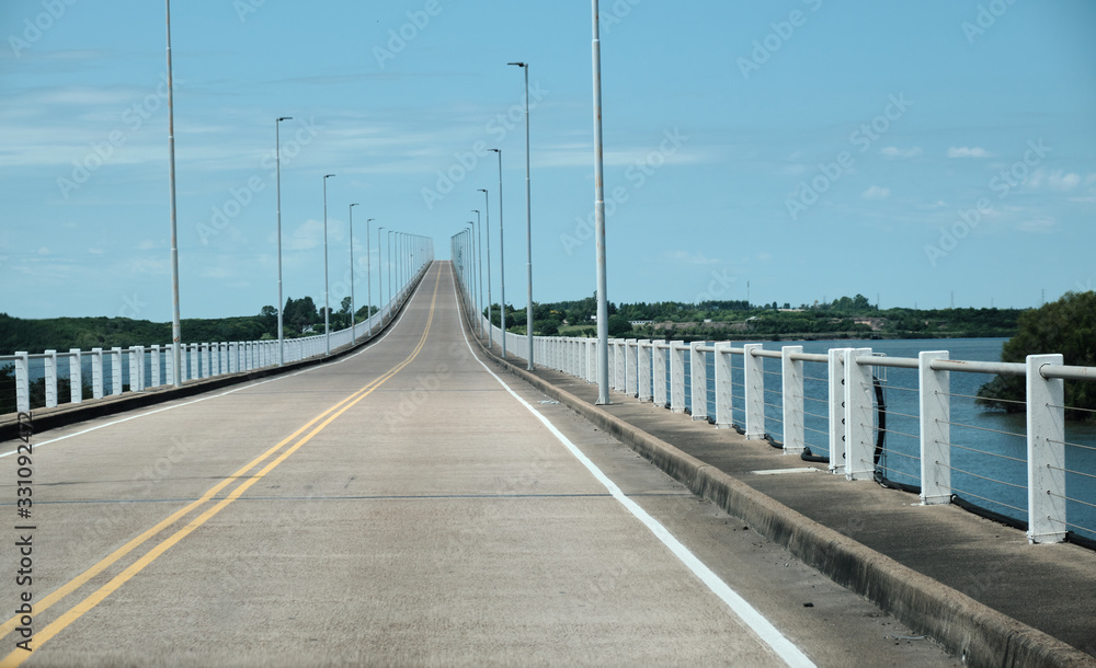 a view from the road of a bridge in the frontier between argentina and uruguay