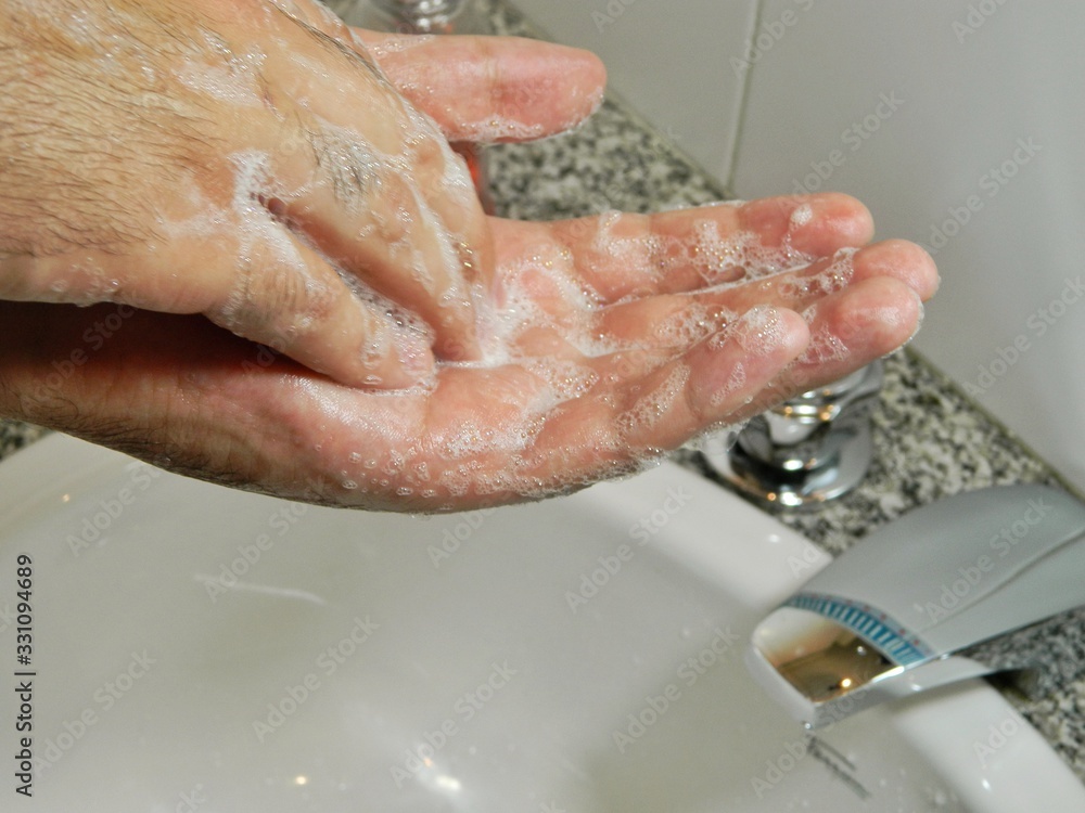Fototapeta premium washing hands with soap in sink