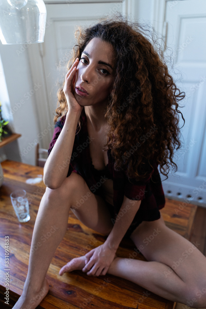 Young woman alone at home in the kitchen Young woman alone at home in the kitchen