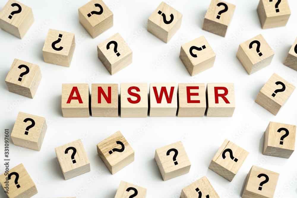 Obraz premium Answer wood cubes surrounding by many question mark cubes for frequent ask question