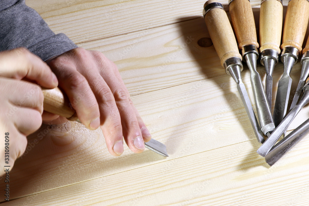 Chisels. Assortment of chisel of wood for carpentry. Hand holding chisel. Chisels. Assortment of chisel of wood for carpentry. Hand holding chisel.