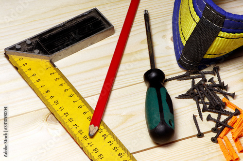 Different tools on a wooden background. Carpenter tools on a table. photo