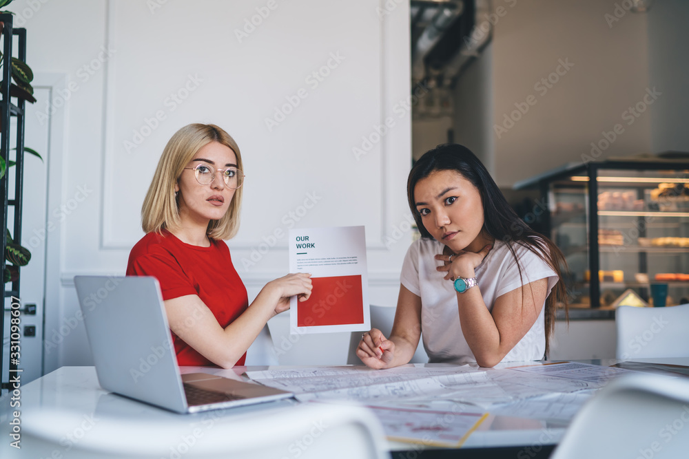 Young smart coworkers working with documents Young smart coworkers working with documents