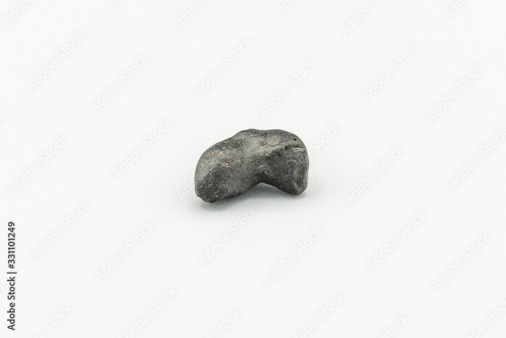 Black magnetic Atacaimite Tektite Meteorite isolated, a rock formed in a big meteorite collision at Atacama Desert. Amazing fusion textures over the surface because of the extreme temperatures reach
Black magnetic Atacaimite Tektite Meteorite isolated, a rock formed in a big meteorite collision at Atacama Desert. Amazing fusion textures over the surface because of the extreme temperatures reach