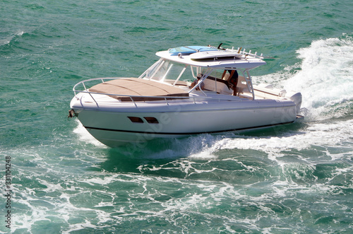 High-end sport fishing boat powered by three outboard engines off Miami Beach on the Florida Intra-Coastal Waterway.