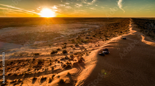 Outback travellers in their 4WD's enjoy sunset drinks atop Big Red sand dune west of Birdsville.