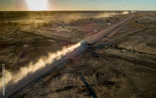 Four wheel drives cross the SA/QLD border at sunset on the Birdsville Track photo