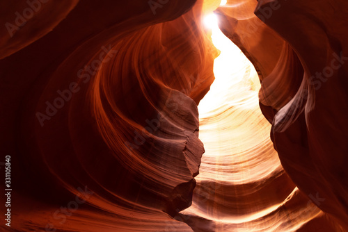 Unique & stunning Antelope Canyon located near Page, Arizona. Looking up into the famous tourist area during summer time with sun shining down through canyon walls 