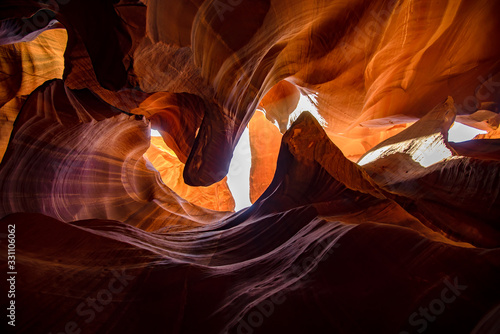 Unique & stunning Antelope Canyon located near Page, Arizona. Looking up into the famous tourist area during summer time with sun shining down through canyon walls 