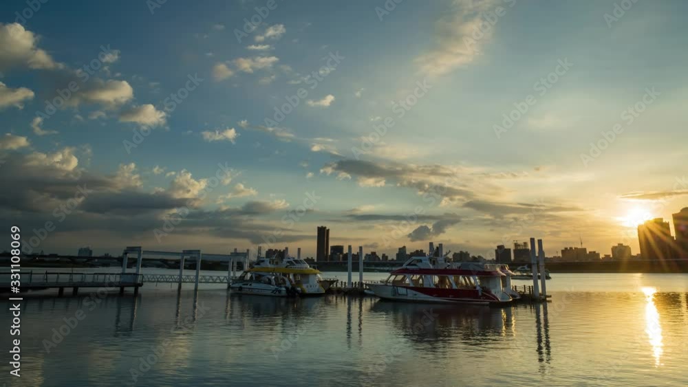 Beautiful sun set time lapse of the Dadaocheng Pier with some boats Beautiful sun set time lapse of the Dadaocheng Pier with some boats