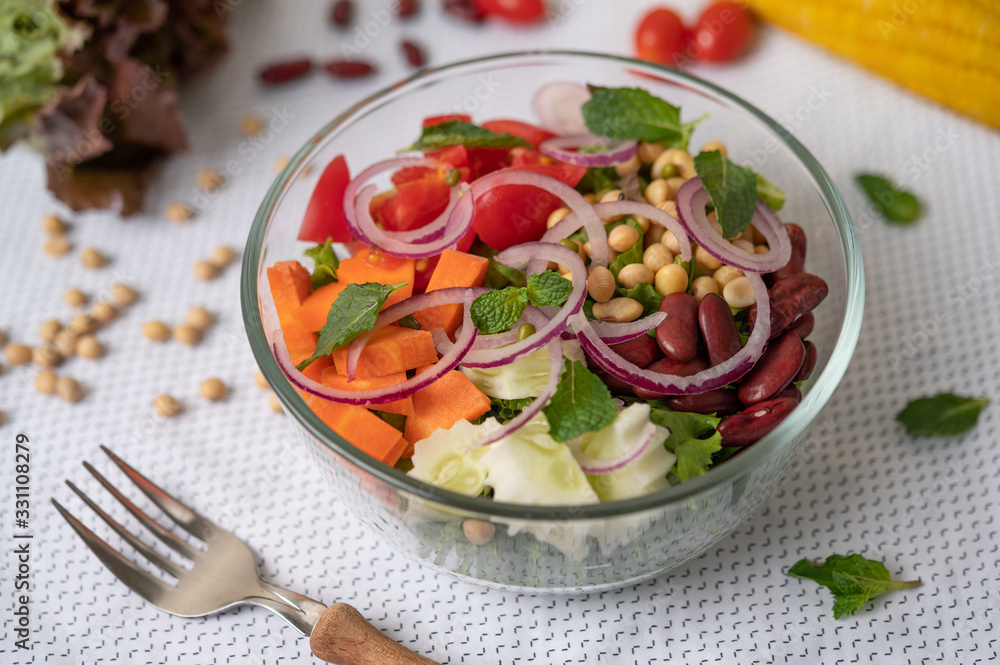 Fruit and vegetable salad in a glass cup on a white ground