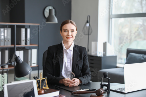 Tableau sur toile Female lawyer sitting at workplace in office