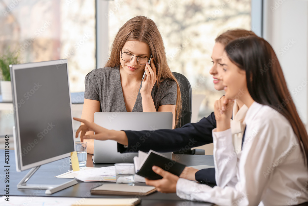 Beautiful young businesswomen working together in office Beautiful young businesswomen working together in office