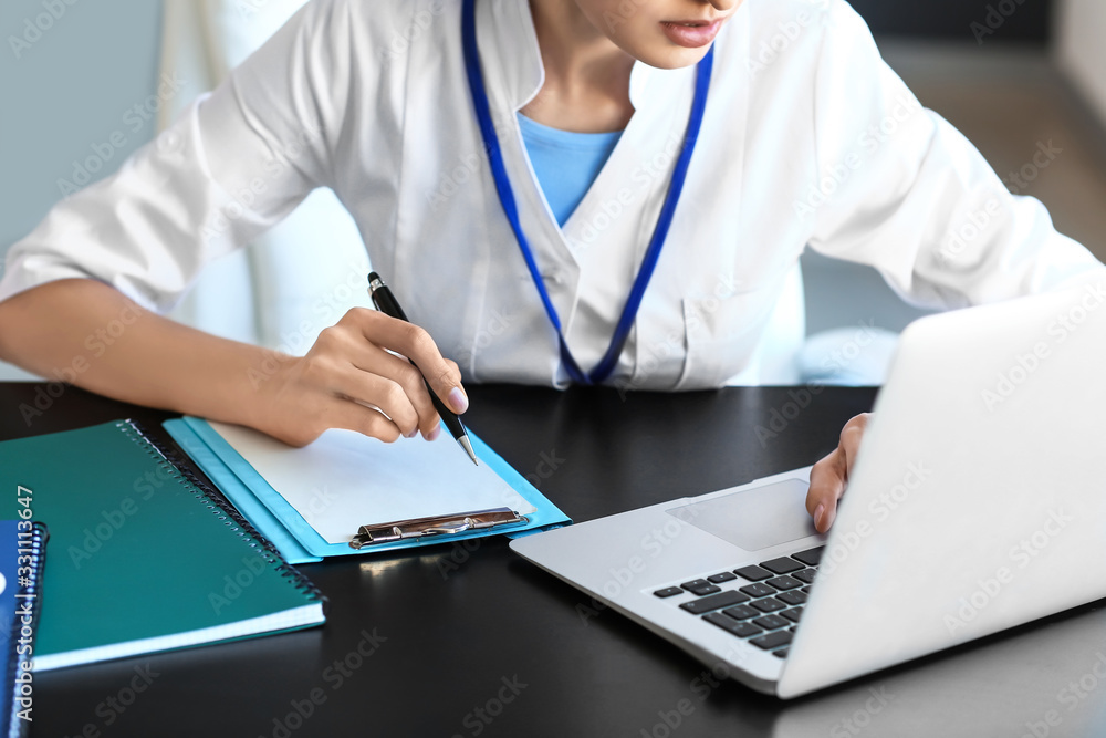 Young female doctor working in clinic, closeup Young female doctor working in clinic, closeup