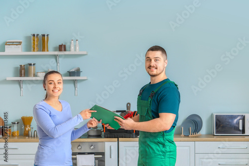 Handsome plumber giving doc...