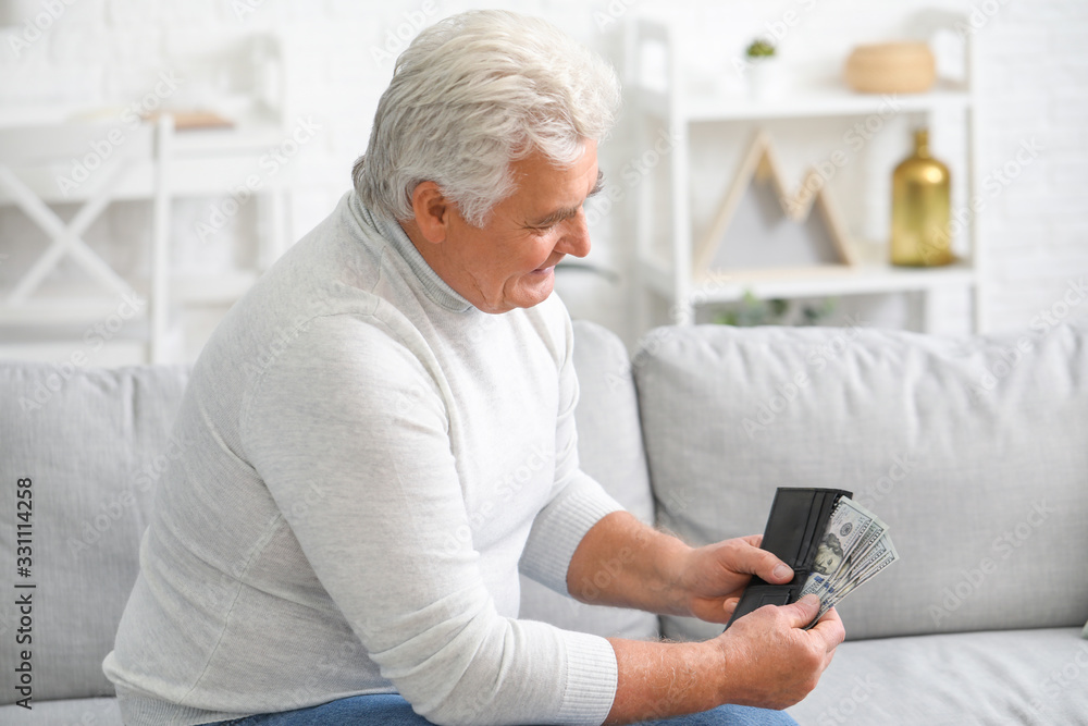 Senior man with purse at home Senior man with purse at home