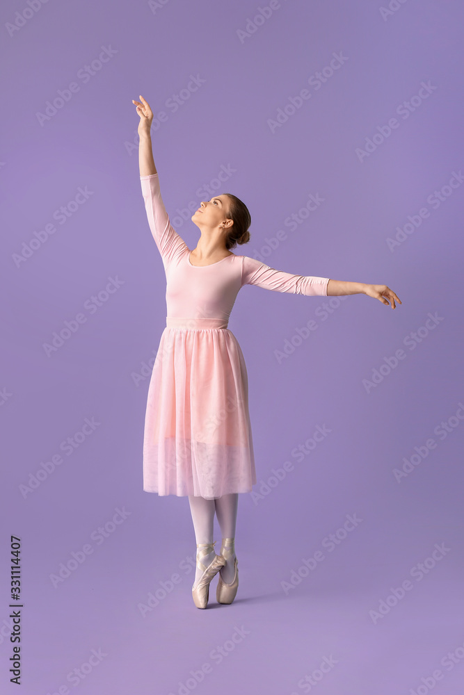 Beautiful young ballerina on color background