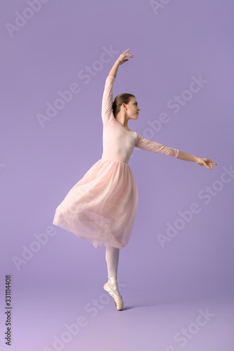 Fototapeta Naklejka Na Ścianę i Meble -  Beautiful young ballerina on color background