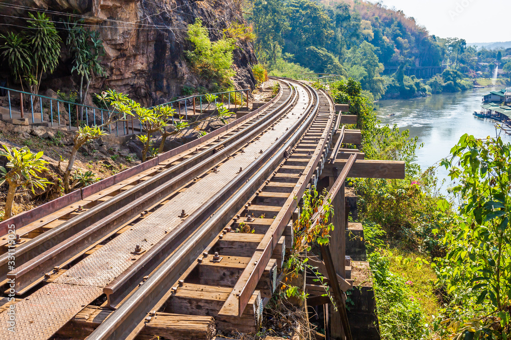 Fototapeta premium Landscape of Bridge River Kwai at Kanchanaburi, Thailand in morning time. Is a famous place and a tourist destination
