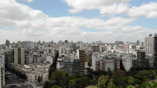 Aerial view of the buildings around Las Heras Park, drone hovering and slowly rotating left to right with a blue sky as background photo