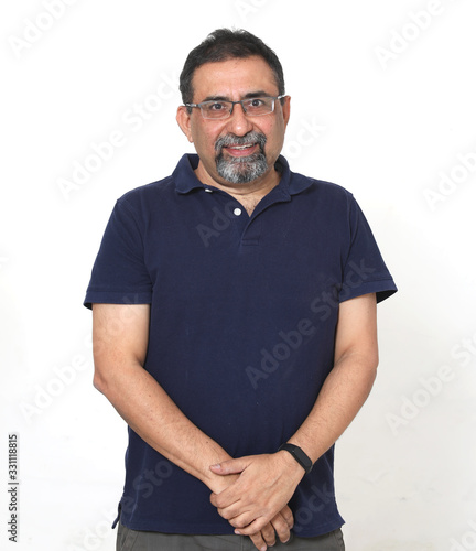 An Indian man with a goatee beard wearing spectacles against a white background. Looking at camera. photo