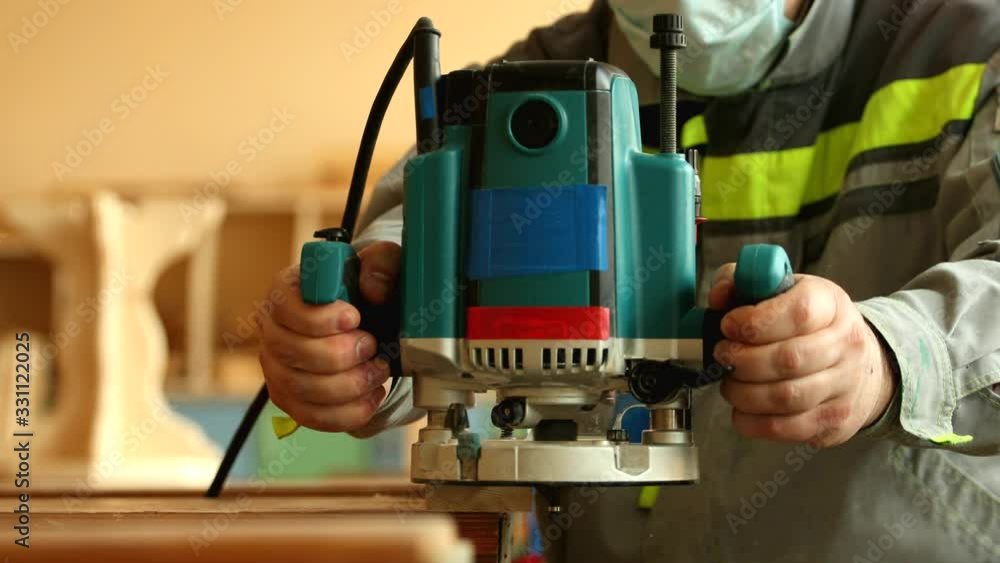 Carpenter work with a milling router machine close up Carpenter work with a milling router machine close up
