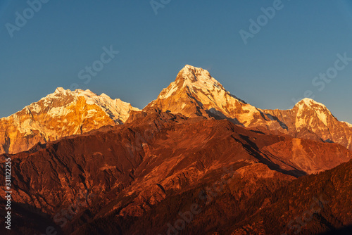 Majestic view of sunset sweeping through Annapurna South and Himchuli from Poon Hill, Ghorepani, Nepal