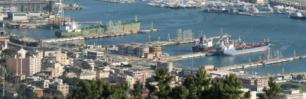 Oil port next to the city, with large tanks and ship