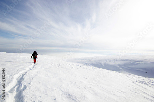 climber man walking in the snow