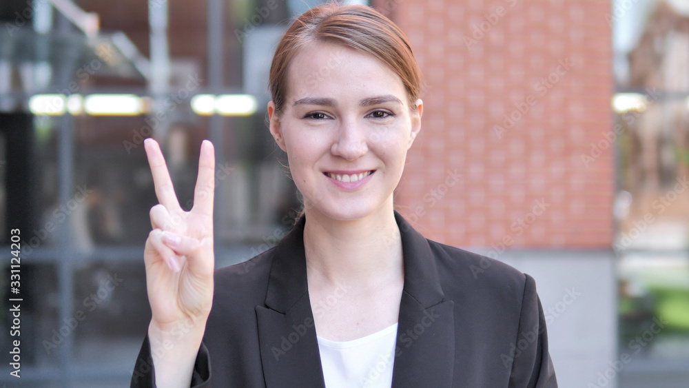 Sign of Victory by Young Businesswoman Standing Outdoor Sign of Victory by Young Businesswoman Standing Outdoor
