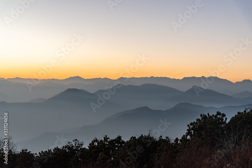 Stacked mountain ridges seen during golden hour of sunset from Poonhill Ghorepani Nepal photo