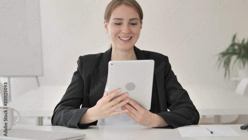Young Businesswoman Celebrating Success on Tablet Young Businesswoman Celebrating Success on Tablet