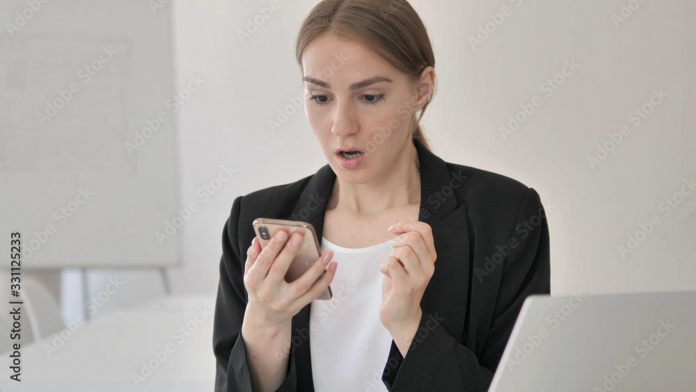 Young Businesswoman in Shock Using Smartphone Young Businesswoman in Shock Using Smartphone