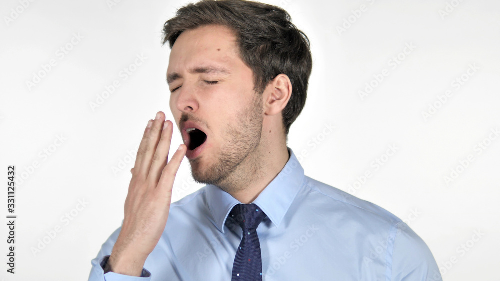 Tired Young Businessman Yawning on White Background Tired Young Businessman Yawning on White Background