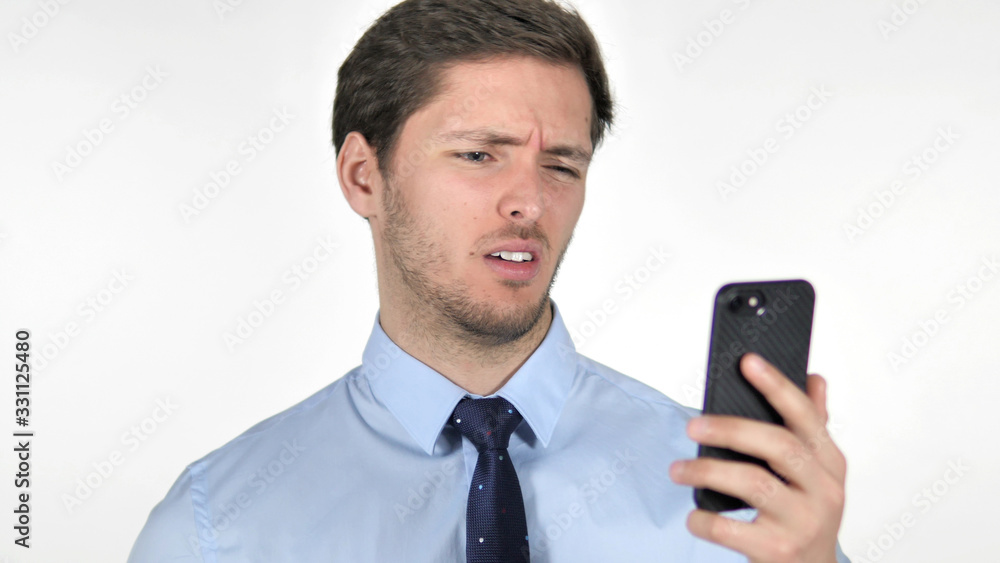 Young Businessman Reacting to Loss on Smartphone on White Background Young Businessman Reacting to Loss on Smartphone on White Background