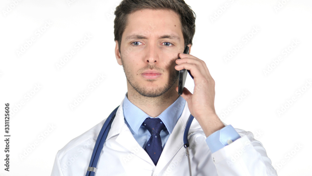 Young Doctor Talking on Smartphone, White Background Young Doctor Talking on Smartphone, White Background