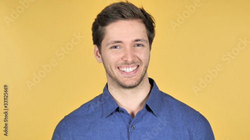 Yes, Admiring Casual Young Man on Yellow Background