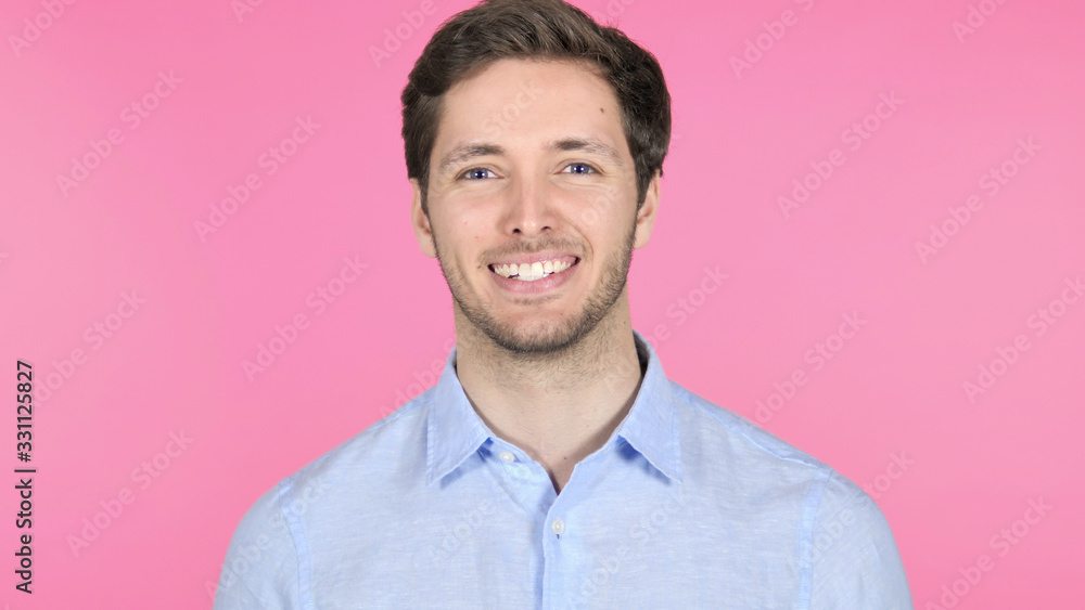 Smiling Young Man Isolated on Pink Background Smiling Young Man Isolated on Pink Background