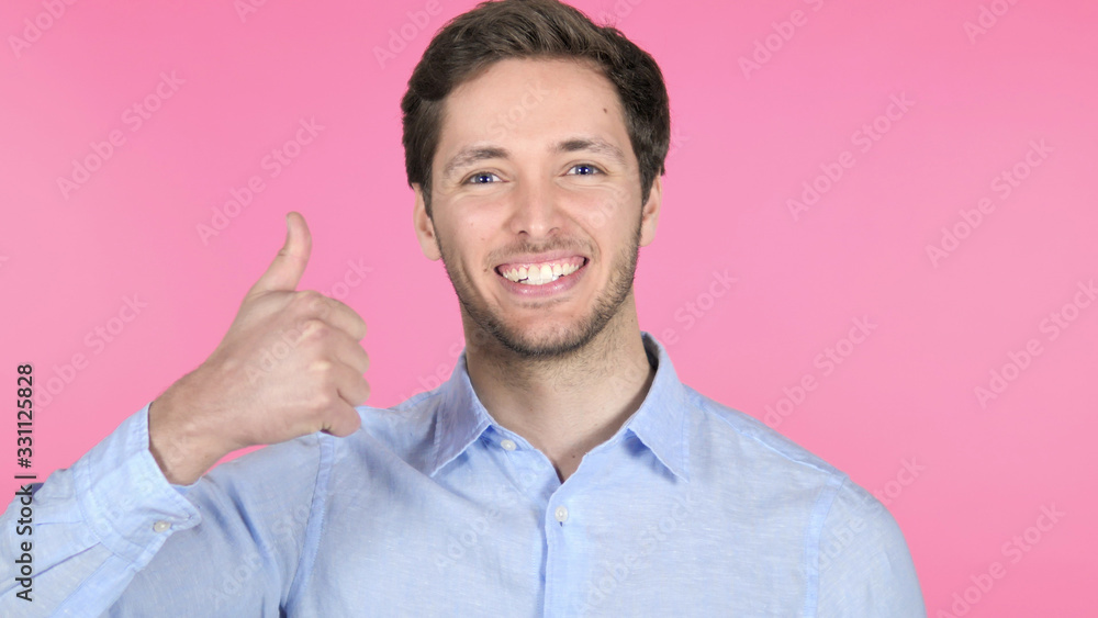 Thumbs Down by Young Businessman on Pink Background Thumbs Down by Young Businessman on Pink Background