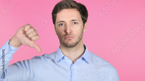 Thumbs Up by Young Man on Pink Background