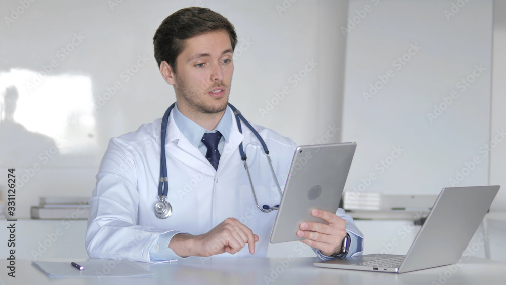 Young Doctor Talking with Patient via Video Chat on Tablet Young Doctor Talking with Patient via Video Chat on Tablet
