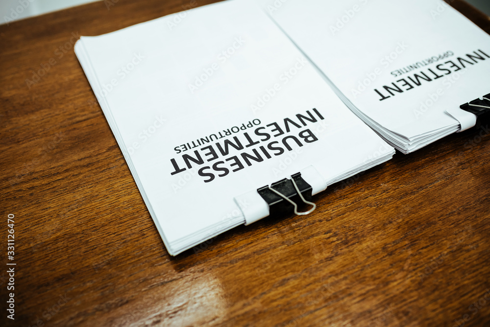 Business investment cover paper put on desk table in office. Business investment cover paper put on desk table in office.