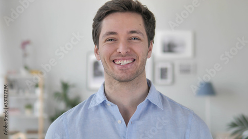 Portrait of Smiling Handsome Young Man Looking at Camera