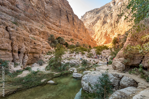 Wadi Shab river canyon with rocky cliffs and green water springs - Sultanate of Oman