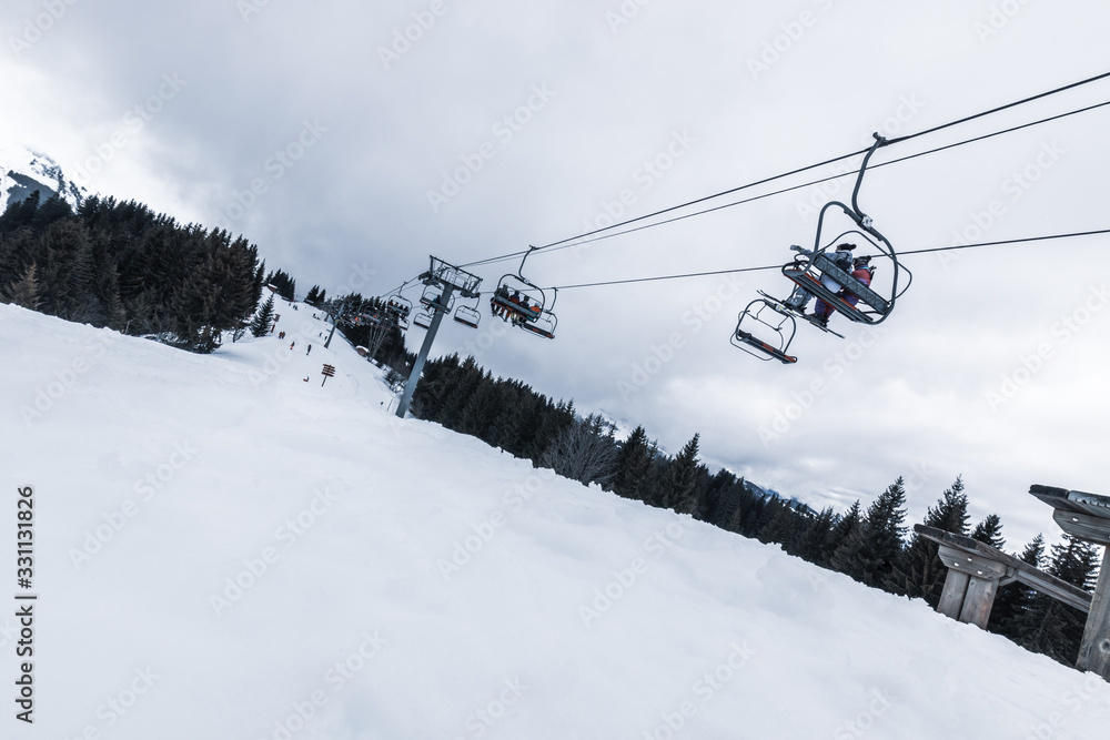 View of the chairlifts of the Morzine ski slopes in the French Alps during winter