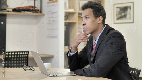 Pensive Young African Businessman Thinking at Work