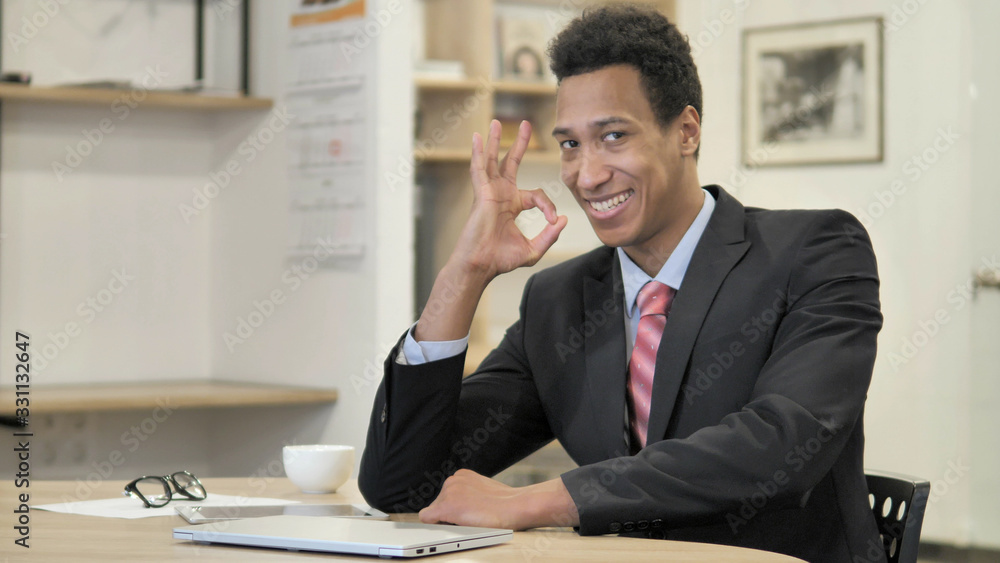 Okay Sign by Young African Businessman at Work Okay Sign by Young African Businessman at Work